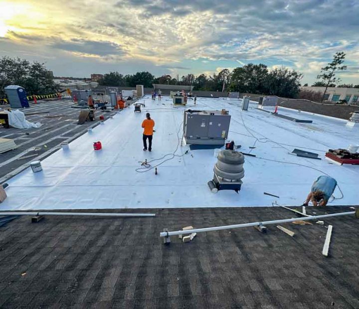 A team of roofers working at a commercial property roofing project